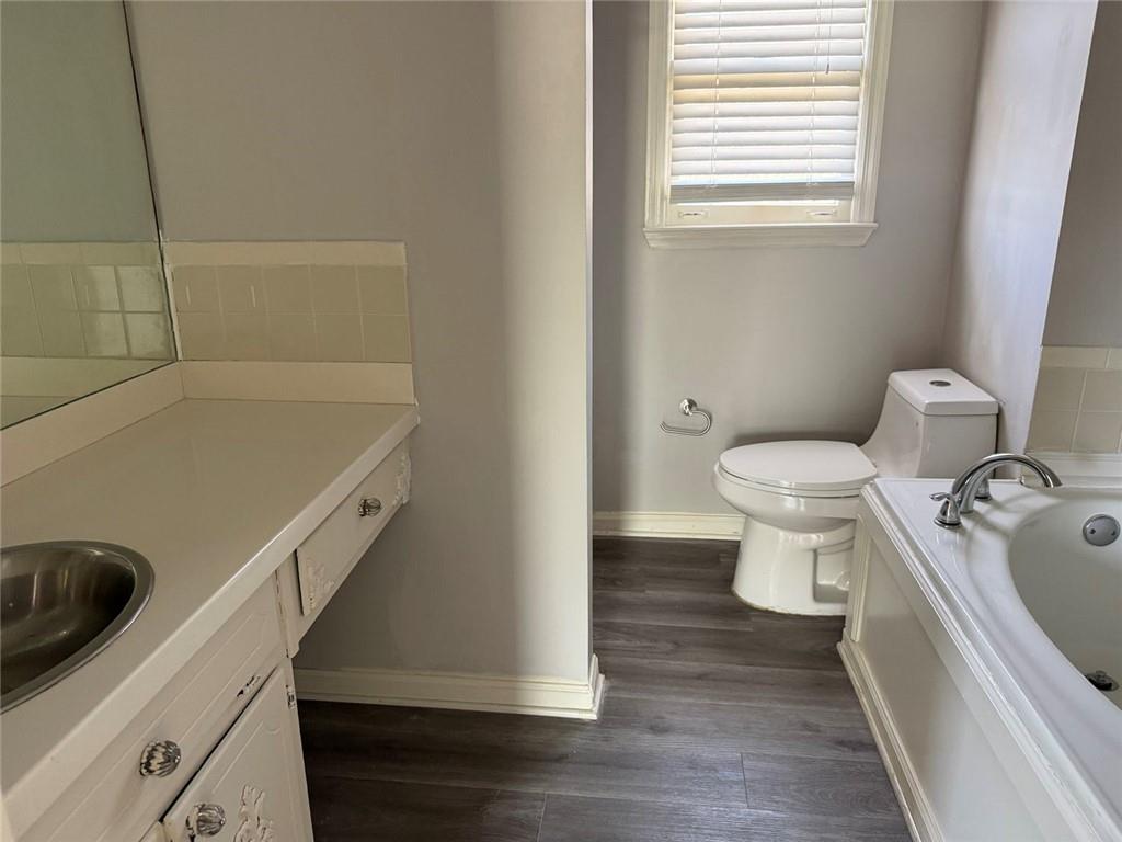 3383 Hamilton Mill Road Buford, GA 30519 - Photo 8 of 18 a bathroom with a sink and a toilet