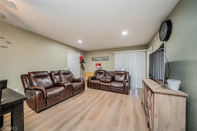 a bedroom with furniture and a flat screen tv
