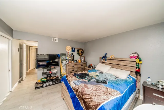 a bed sitting in a bedroom next to a window