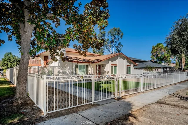 a front view of a house with a garden
