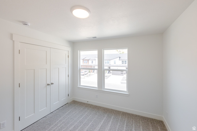 5228 South Acacia Drive, Unit 808 Mapleton, UT 84664 - Photo 17 of 22 Neutral wall paint, two-panel interior doors, light-colored carpeting, recessed lighting, and dual windows with white trim
