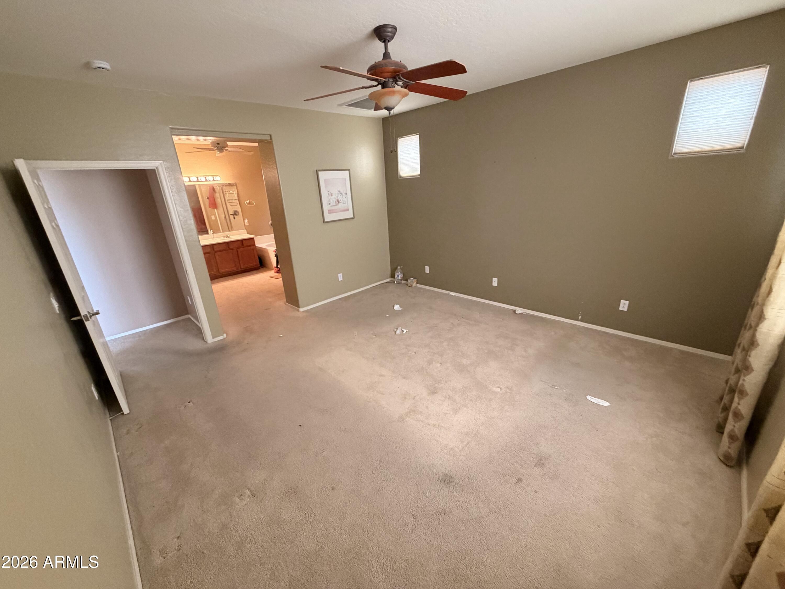 19466 East Reins Road Queen Creek, AZ 85142 - Photo 5 of 10 en empty room with windows and fan