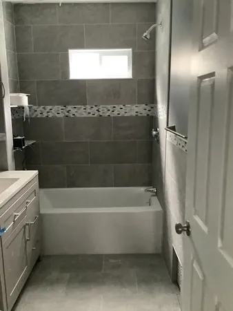 a bathroom with a bathtub and a shower