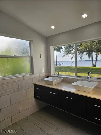 a bathroom with a sink a large mirror and a bathtub