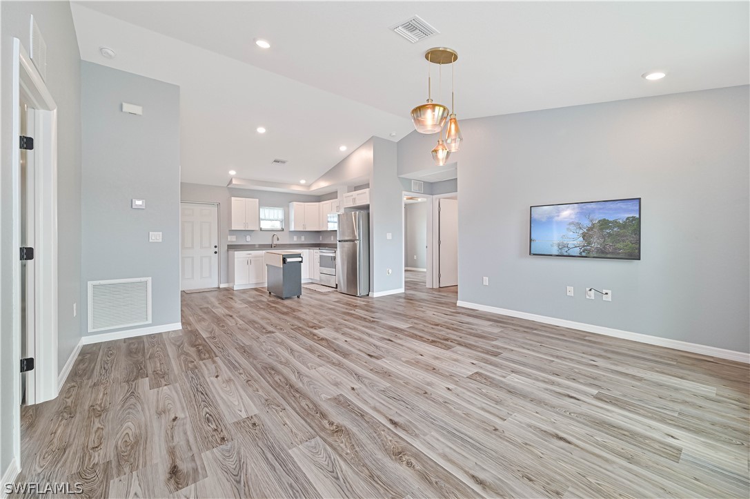 7085 Brazil Circle LaBelle, FL 33935 - Photo 18 of 32 a view of a kitchen with a sink and wooden floor