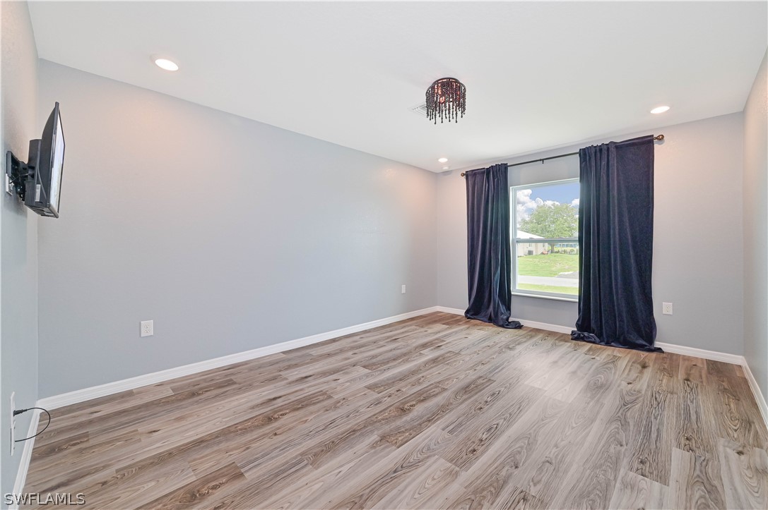 7085 Brazil Circle LaBelle, FL 33935 - Photo 21 of 32 a view of an empty room with wooden floor and a window