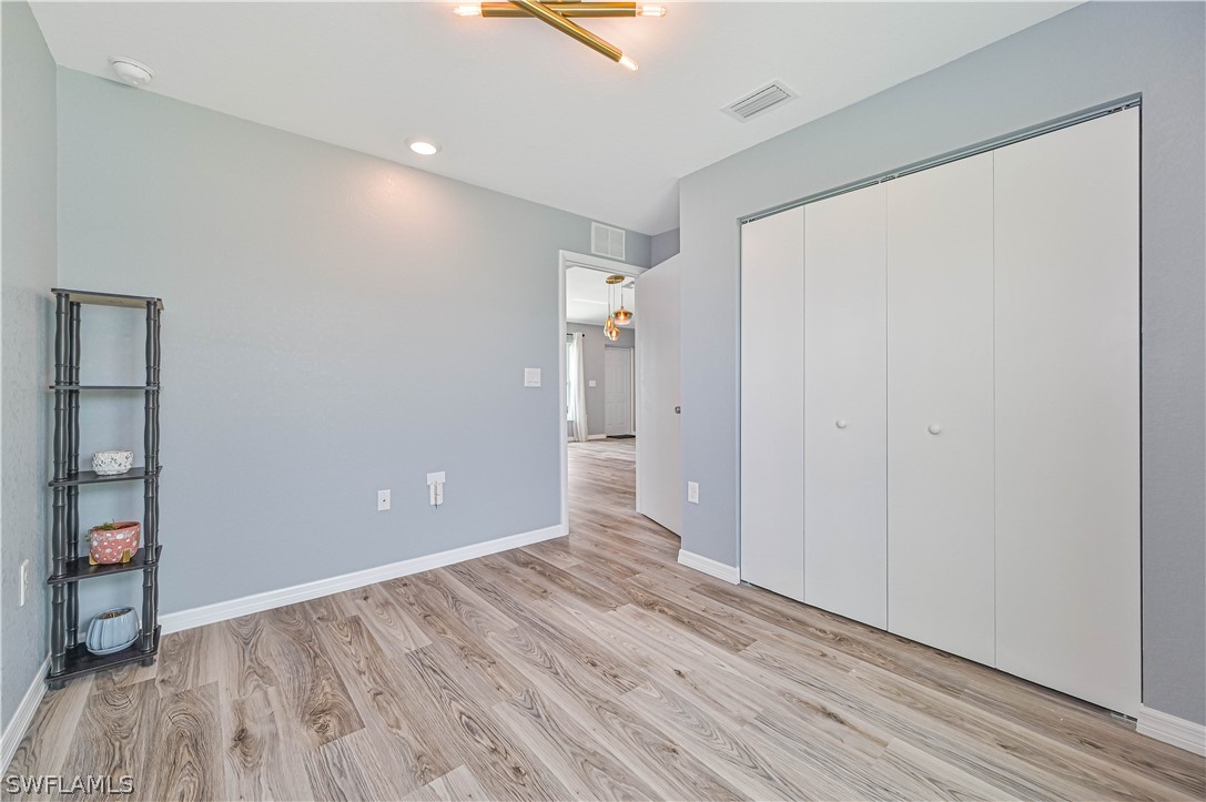 7085 Brazil Circle LaBelle, FL 33935 - Photo 27 of 32 wooden floor in an empty room with a window