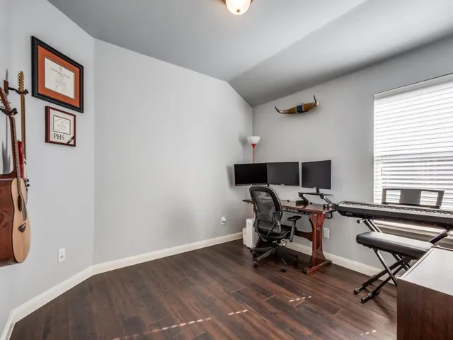 a view of a workspace with furniture and a window