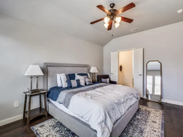 a bedroom with a bed and a chandelier