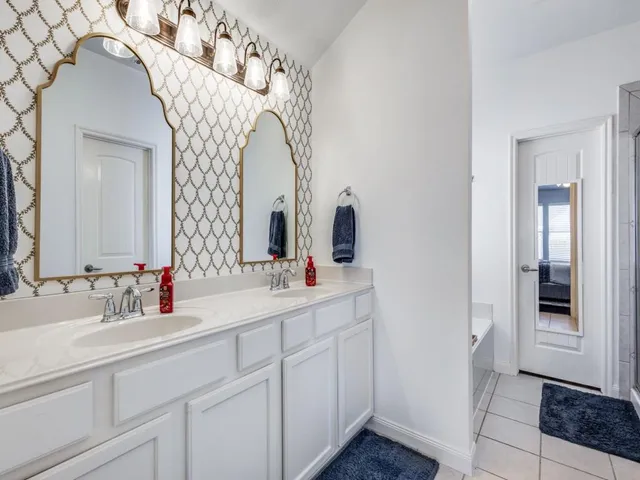 a bathroom with a double vanity sink and mirror