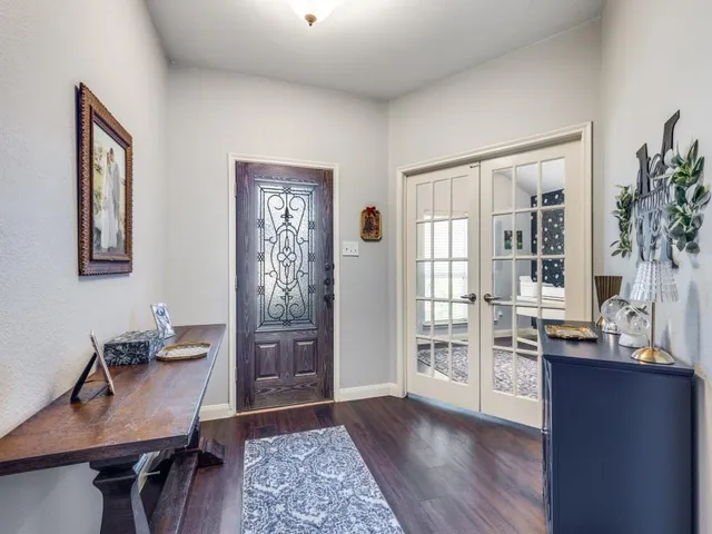 a view of a workspace with furniture and window