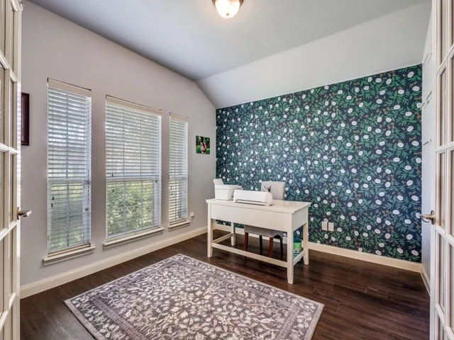 a bench sitting in a room next to a window