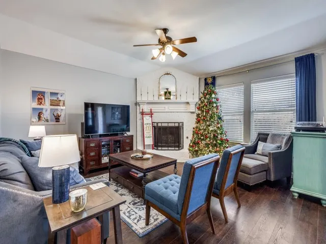 a living room with furniture a fireplace and a flat screen tv