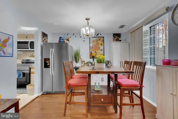 a dining room with furniture a chandelier and window