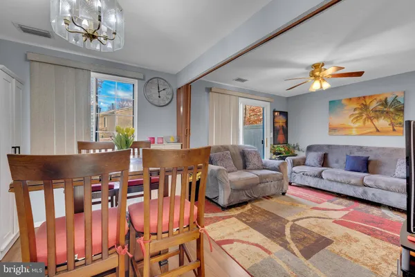 a living room with furniture a chandelier and a window