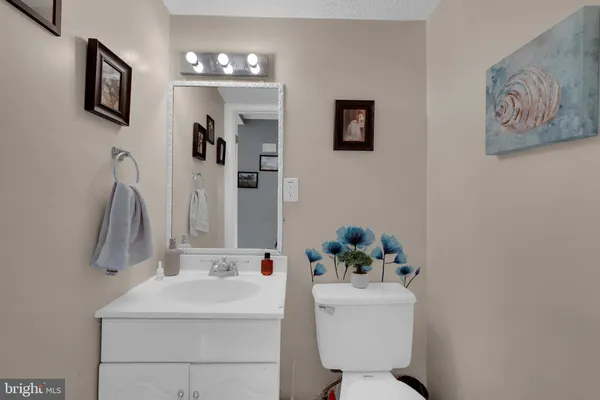 a bathroom with a sink toilet and mirror