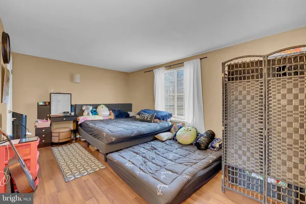 a bedroom with furniture and a window