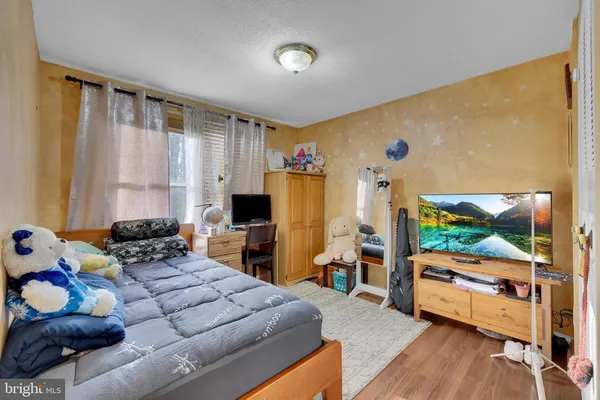 a bedroom with furniture and a flat screen tv