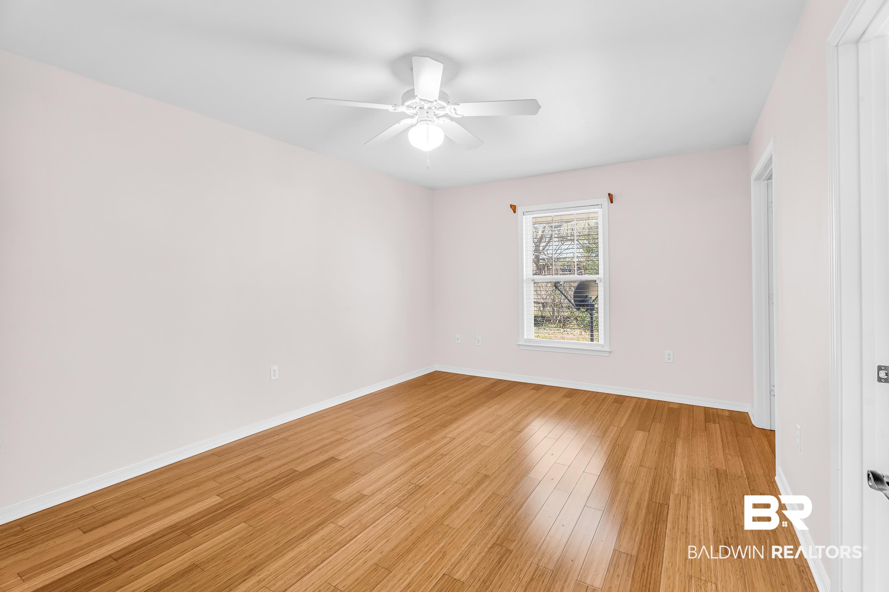22095 8th Street Silverhill, AL 36576 - Photo 29 of 42 Unfurnished bedroom with light wood finished floors and ceiling fan