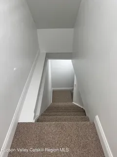 an empty room with windows and ceiling fan