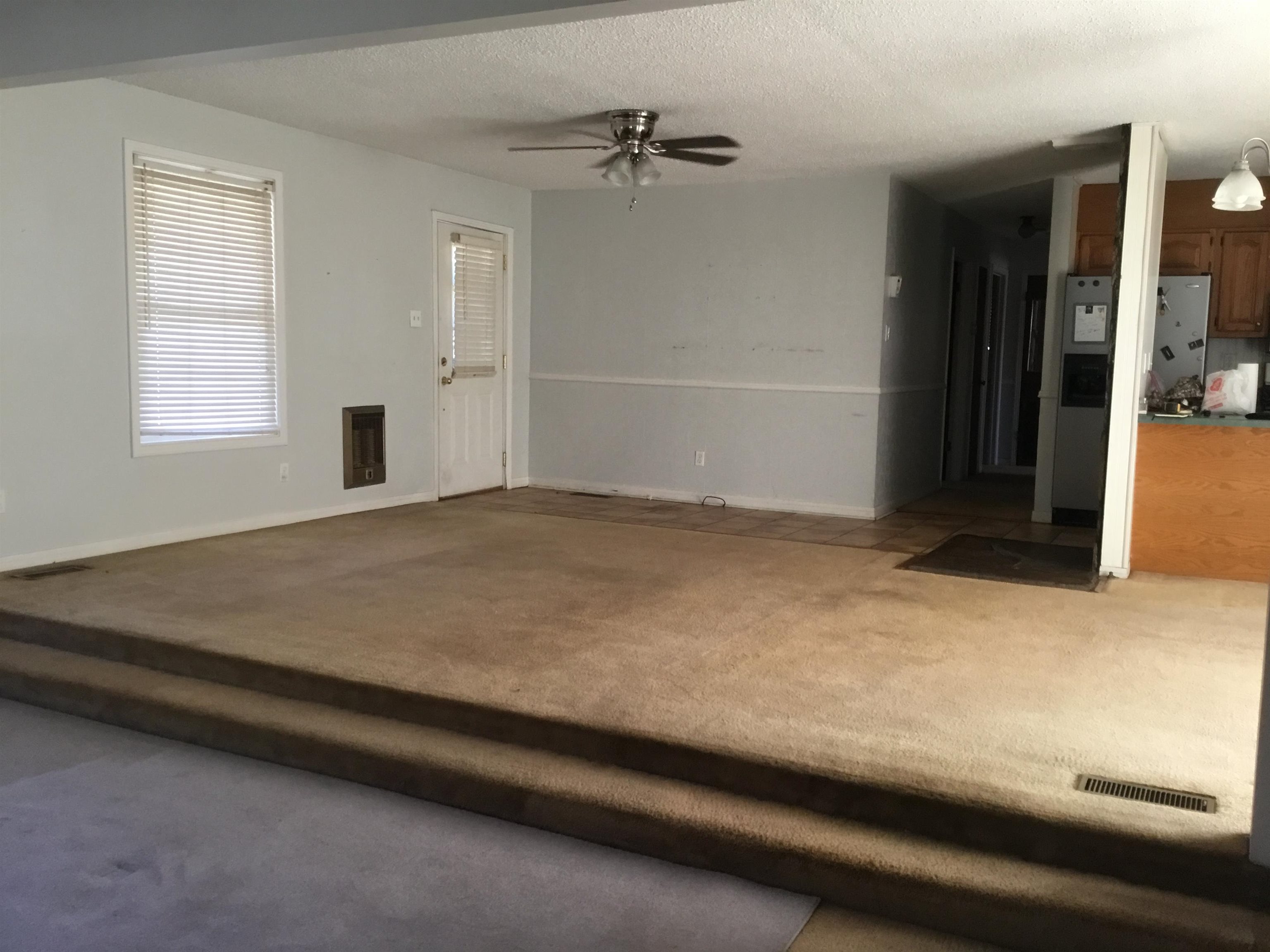367 Crabtree Road Selmer, TN 38375 - Photo 6 of 23 Unfurnished living room featuring carpet flooring, a ceiling fan, and a textured ceiling