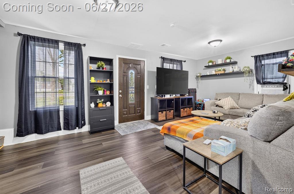 7715 Beech Daly Road Taylor, MI 48180 - Photo 13 of 21 Spacious living area featuring wood-finish flooring, light gray walls, and multiple windows