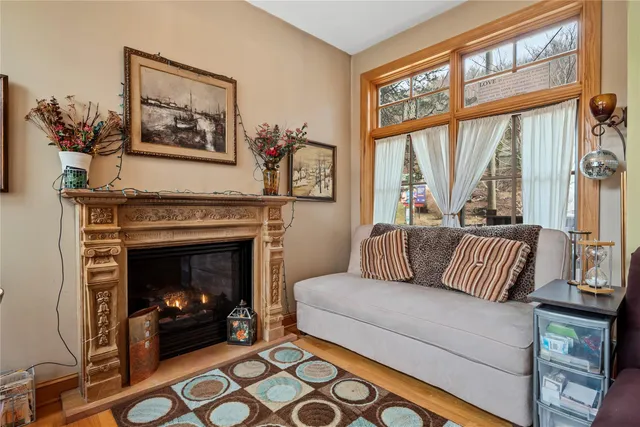 a living room with furniture a large window and a fireplace