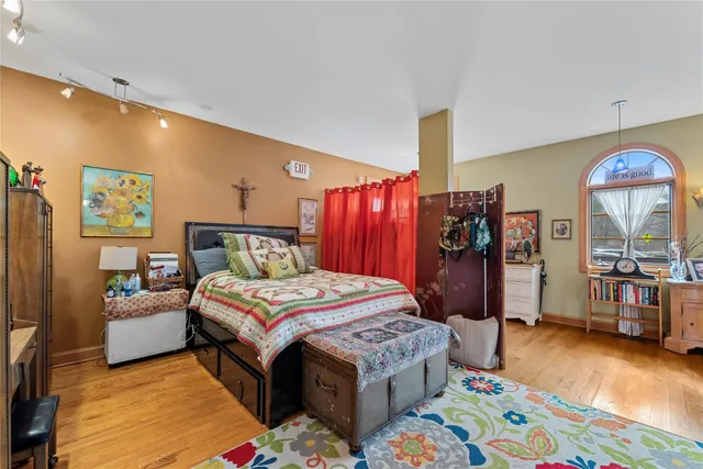 a bedroom with a bed and a mirror