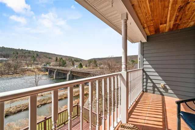 a view of a balcony with wooden floor and fence