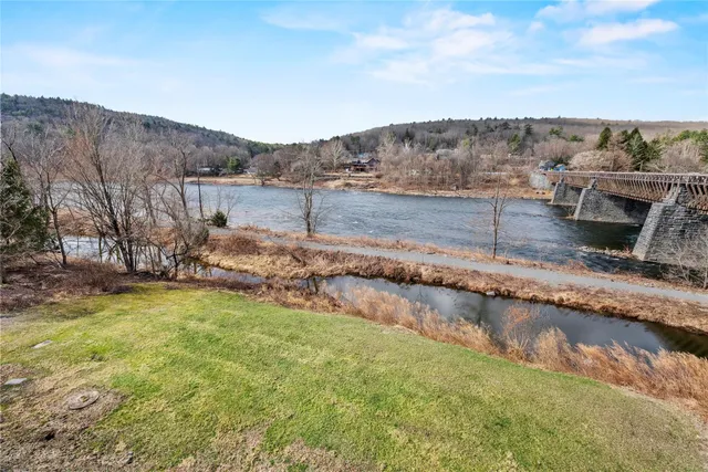 a view of a backyard with wooden fence
