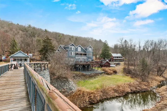 a view of a house with a yard from a balcony