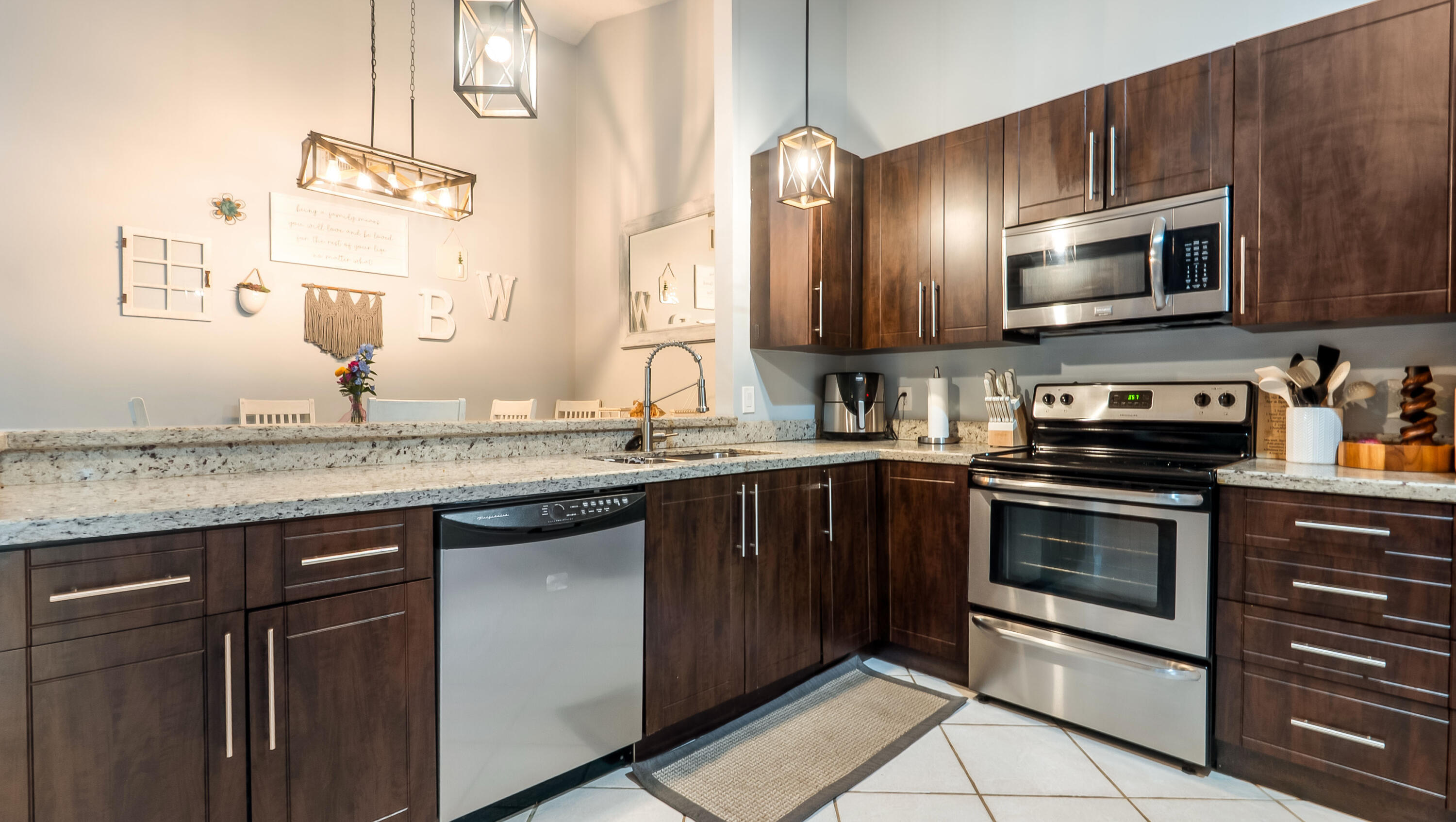 9358 Ketay Circle Boca Raton, FL 33428 - Photo 1 of 28 a kitchen with stainless steel appliances granite countertop a stove microwave and sink