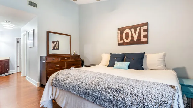 a bedroom with a bed dresser and a window