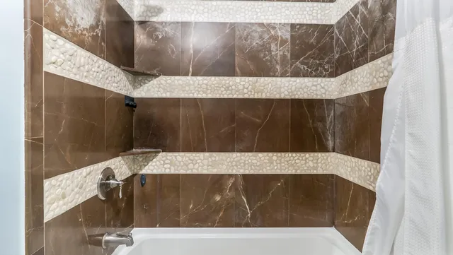 a bathroom with a sink a mirror and shower