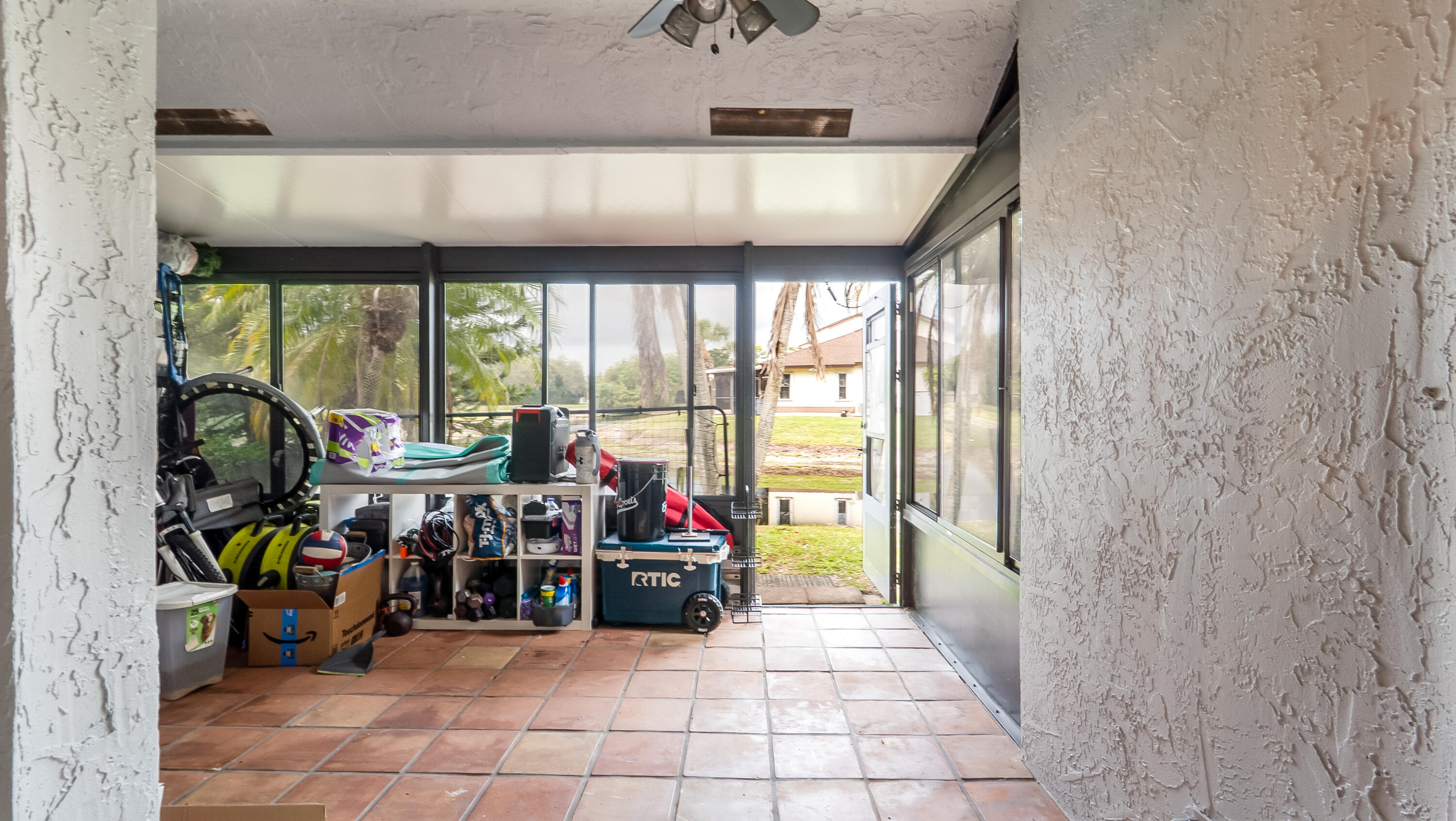 9358 Ketay Circle Boca Raton, FL 33428 - Photo 22 of 28 a view of a garage with a bike and white roof