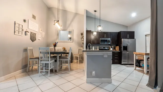 a kitchen with stainless steel appliances a refrigerator sink and stove