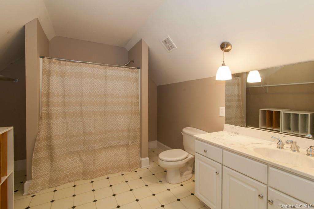 1223 Tom Boyd Road Monroe, NC 28110 - Photo 22 of 24 a bathroom with a sink a toilet a shower and a mirror