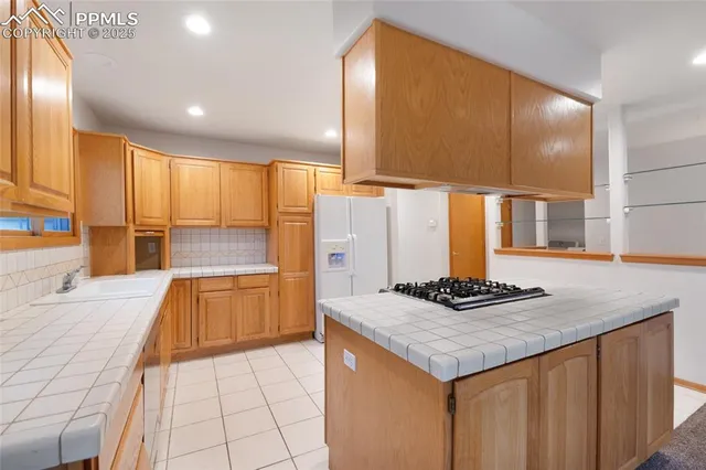 a kitchen with stainless steel appliances granite countertop a sink and a stove