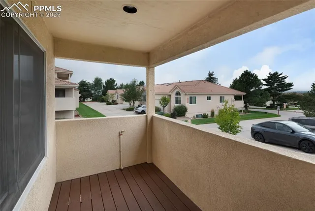 a view of balcony with furniture and wooden floor