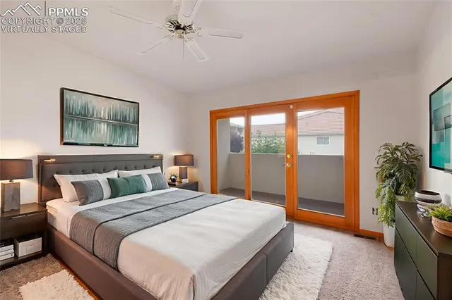 a bedroom with a large bed and a chandelier