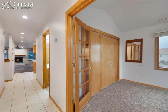 a view of a hallway with closet and a bathroom