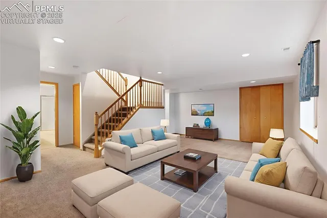 a living room with furniture and a potted plant