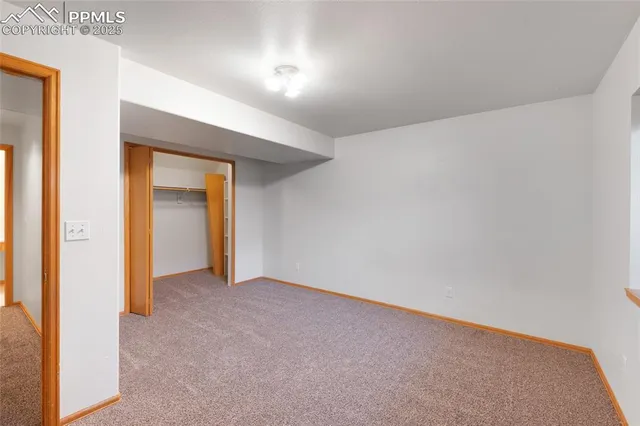 a view of an empty room and a window