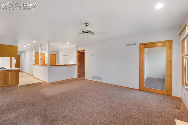 an empty room with a kitchen and a kitchen view