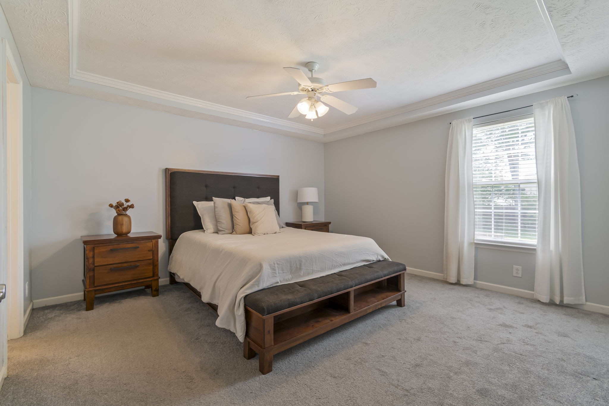 3317 Cornerstone Drive Murfreesboro, TN 37128 - Photo 19 of 33 a bed sitting in a bedroom next to a window and a chandelier