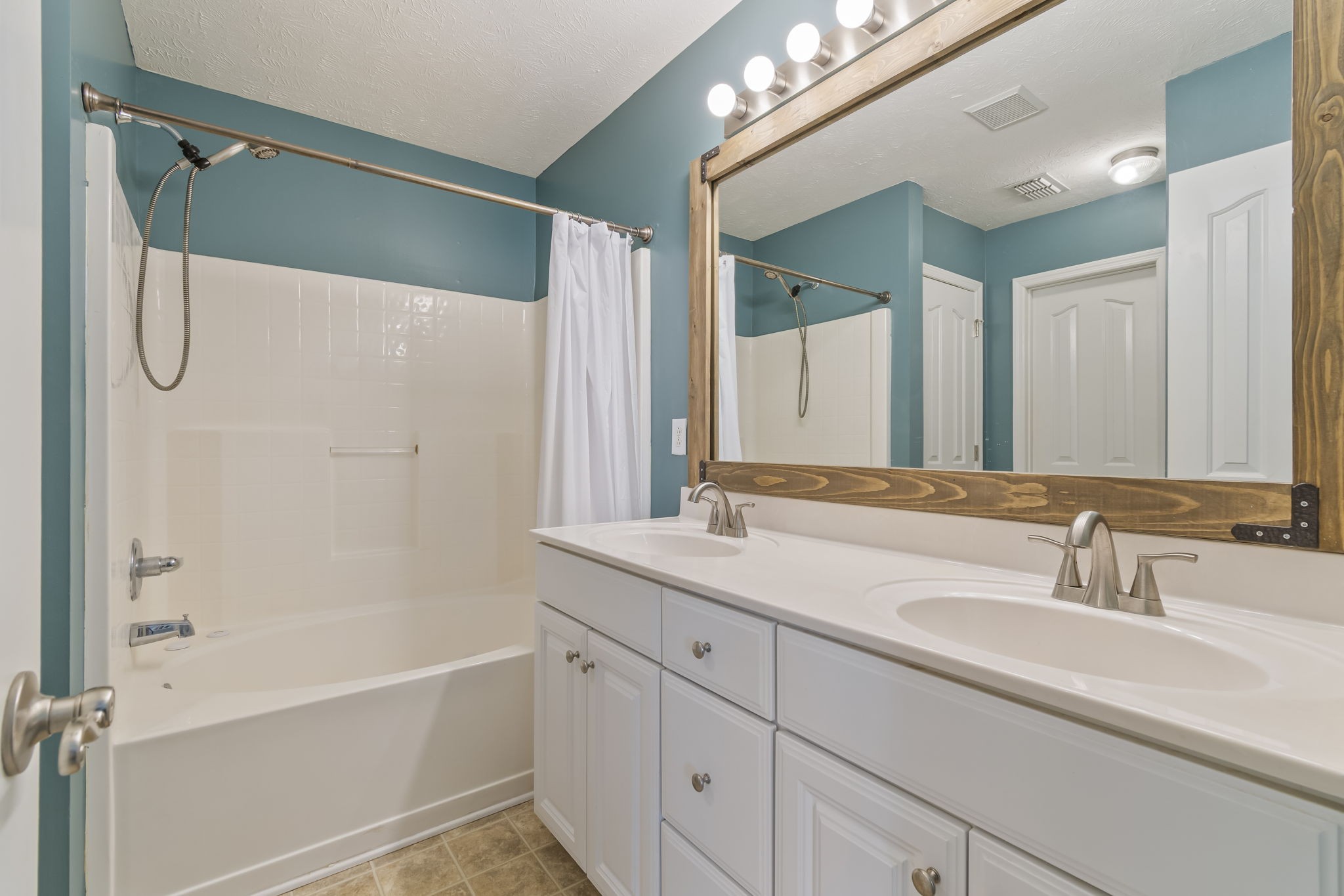 3317 Cornerstone Drive Murfreesboro, TN 37128 - Photo 21 of 33 a bathroom with a granite countertop sink a mirror a vanity and a bathtub