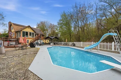 an aerial view of a house with a swimming pool