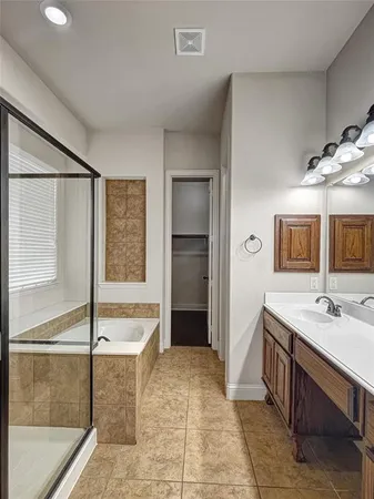 a spacious bathroom with a granite countertop sink and a mirror