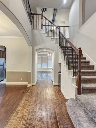 a view of entryway and hall with wooden floor