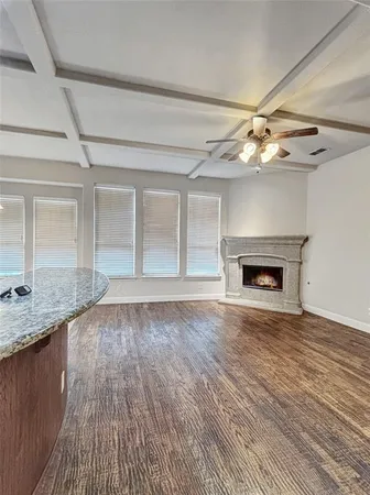 a view of an empty room with a fireplace and a window